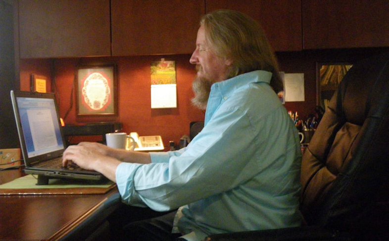 Daniel Green sitting in his office typing on his computer