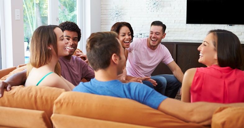 Friends on sofa sharing at a Father Encounters Group