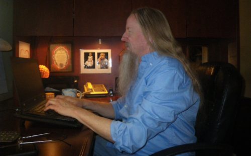 Daniel Green, author and founder of Anakainoo International typing at desk - current photo 2025